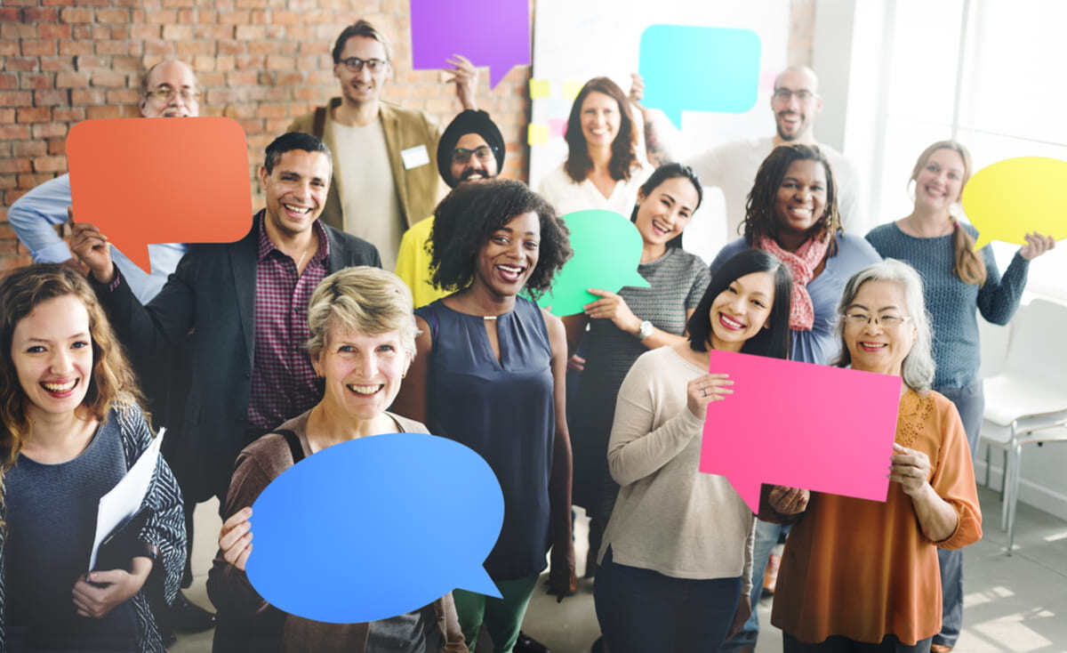 A group of people holding speech bubbles