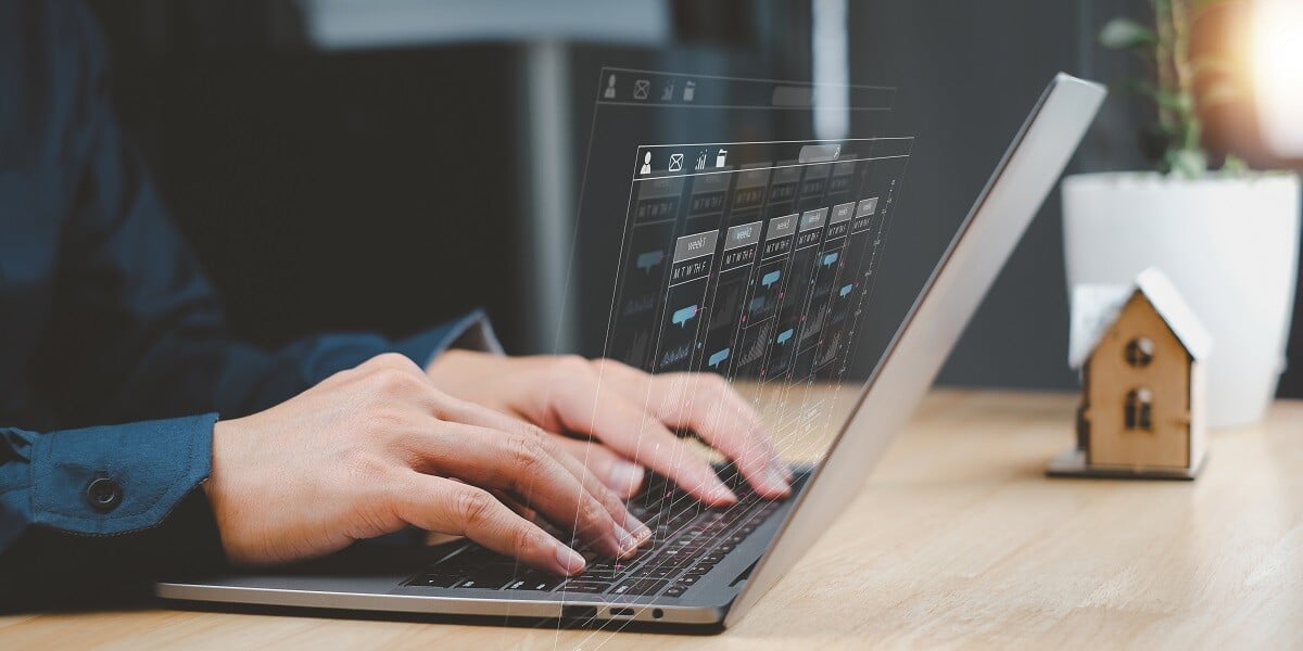 A man working on a laptop with business analytics