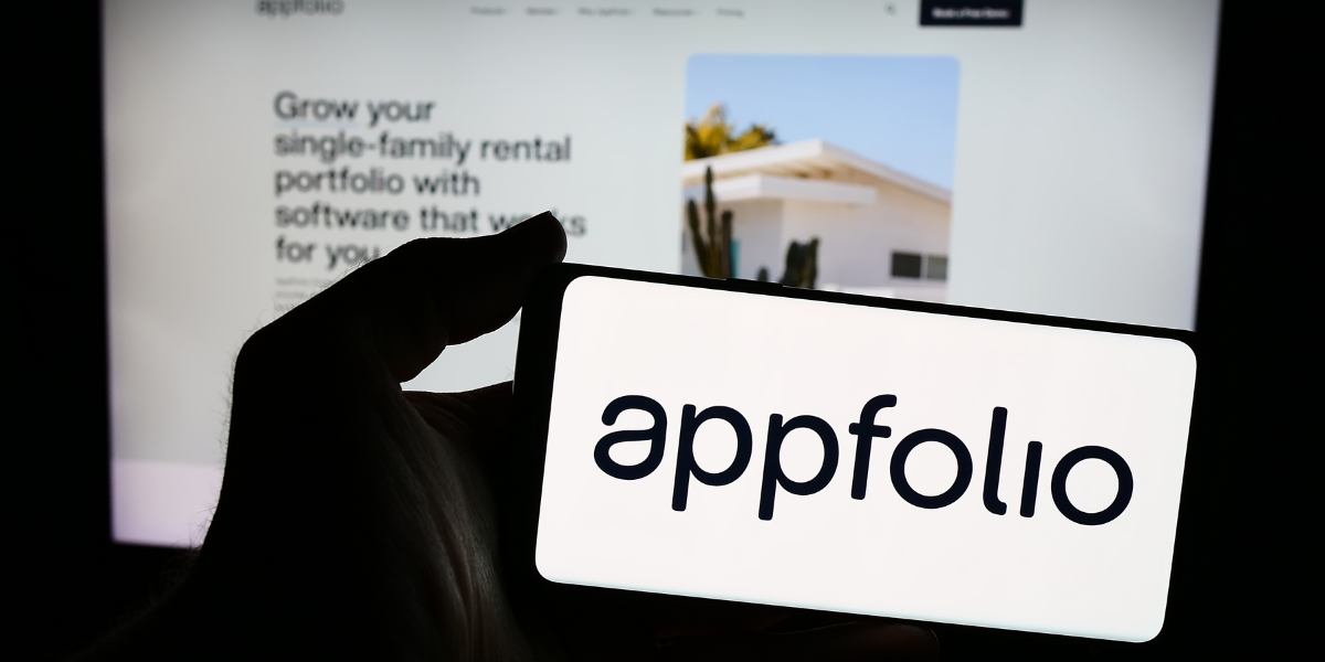 02 Person holding smartphone with logo of US real estate software company AppFolio Inc